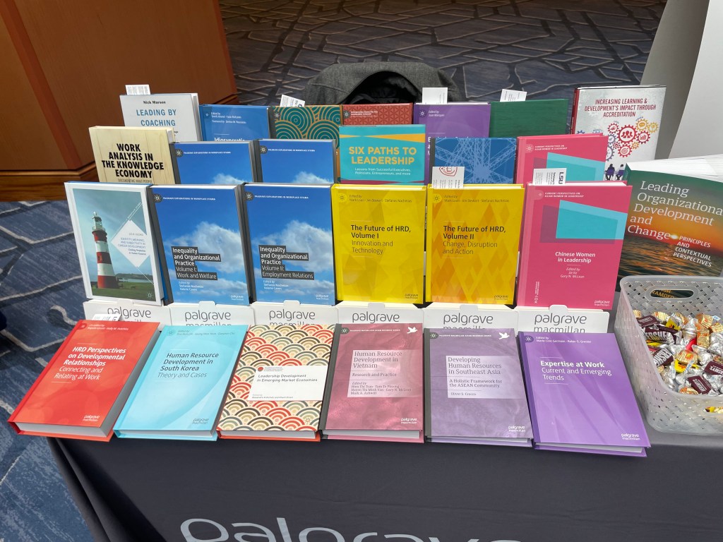 Palgrave Macmillan book table at AHRD including Oliver Crocco's Developing Human Resources in Southeast Asia.